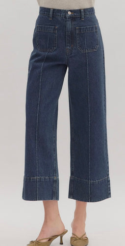 Solid wide-leg ankle-length pants featuring wide cuff hem. Button fly-front zipper closure with pockets at front and back