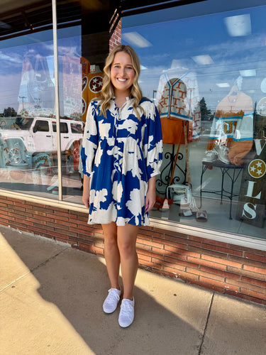 Blue loose fit peasant style floral dress, ruffled neckline detail, front tie, side pockets