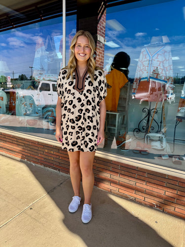 Oversized leopard pattern elasticated dolman sleeve mini dress featuring contrast inset binding neck band collar.